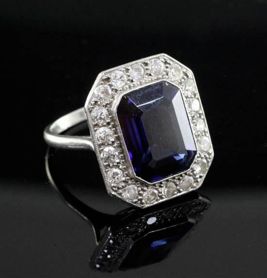 A 1920s/1930s platinum, synthetic sapphire and diamond cluster dress ring, size O.